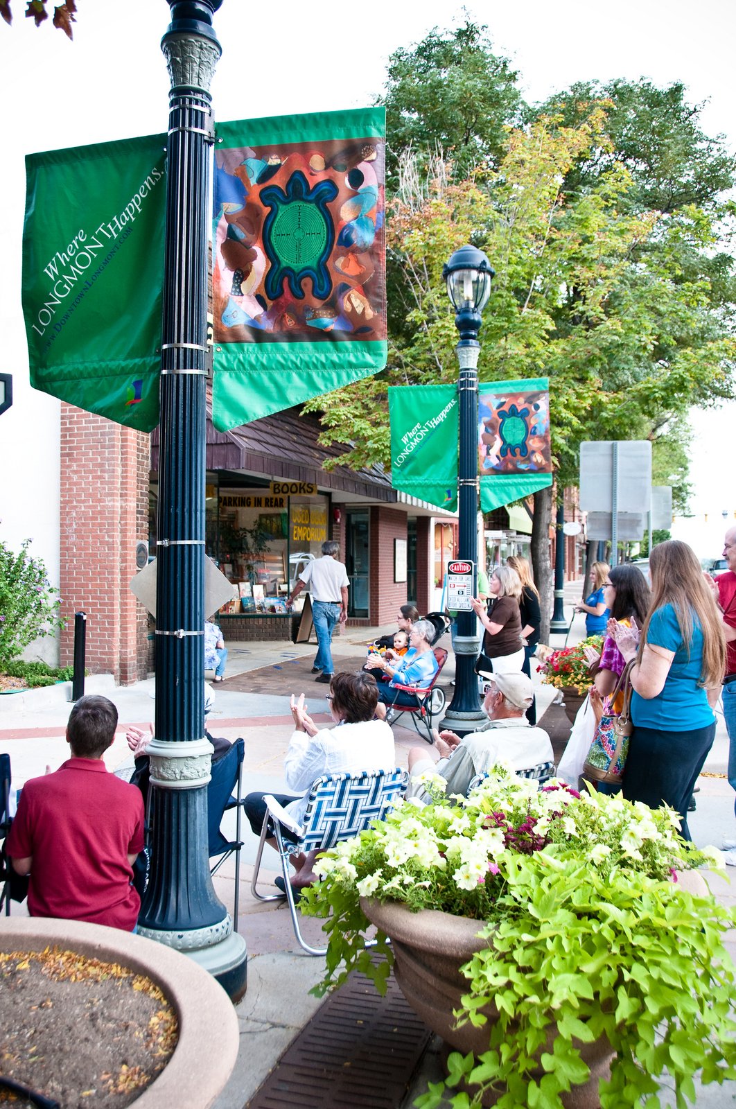 A group of people sitting in downtown Longmont