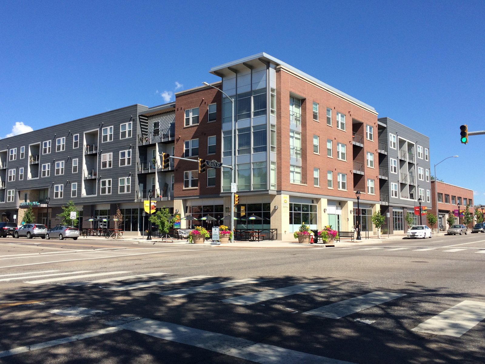 A corner apartment building with the street in the foreground
