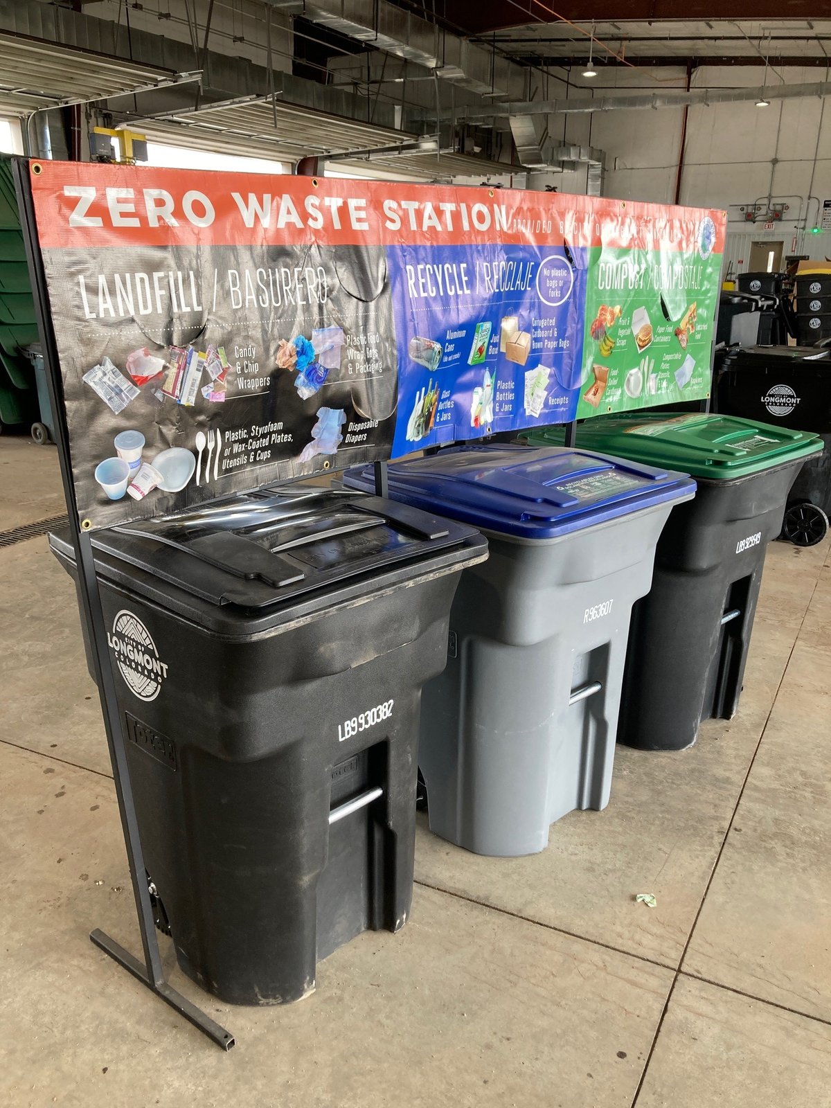 A trash, recycling and composting bins with instructions above them on how to divert waste.