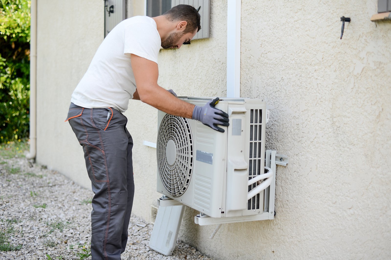 A contractor installing a heat pump