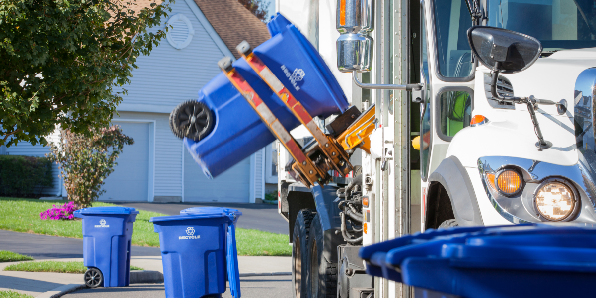 Recycle truck emptying blue recycle bin