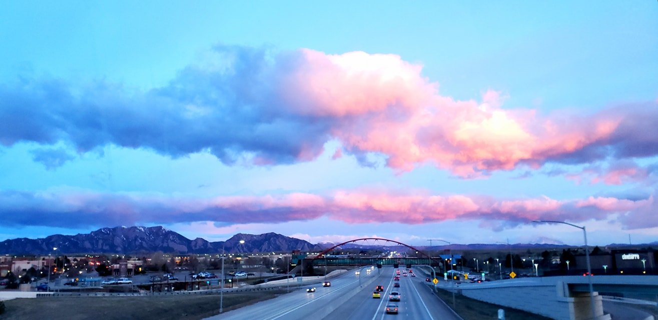 View of mountains and the Superior arched bridge from a distance showing the highway.
